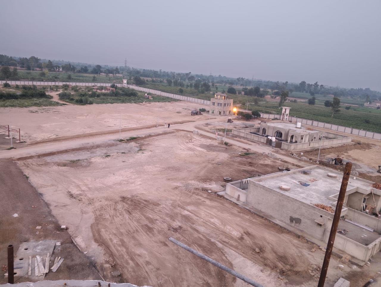 Elevated view of the colony layout, internal roads and buildings under construction.