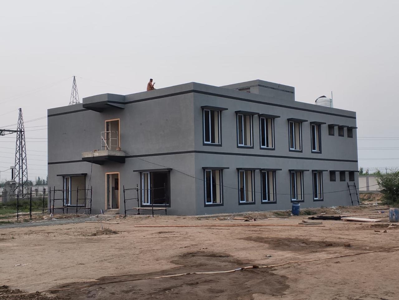 Exterior finishing and window installation at a Lalian residential block.